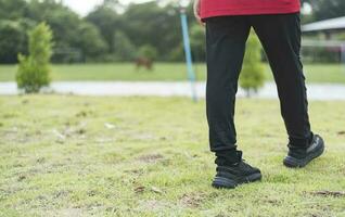 Woman walking in the park alone, summer health care concept. photo