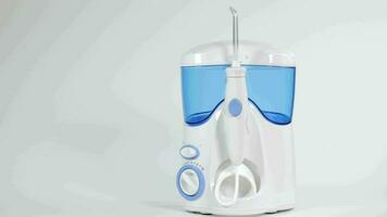 Home dental care device - water flosser in the bathroom. Closeup video