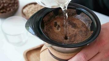 Man prepares coffee in style pour over at home kitchen video