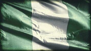 Retro aged Nigeria flag waving on the wind. Old vintage Nigeian banner swaying on the breeze. Seamless loop. video