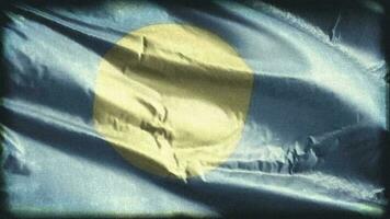 retro envelhecido Palau bandeira acenando em a vento. velho vintage Palauan bandeira balançando em a brisa. desatado laço. video