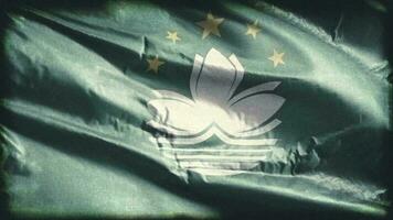 Retro aged Macau flag waving on the wind. Old vintage banner swaying on the breeze. Seamless loop. video