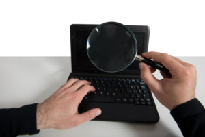 Hacker looking for a password in a laptop with magnifier lens png