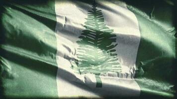 Retro aged Norfolk Island flag waving on the wind. Old vintage banner swaying on the breeze. Seamless loop. video