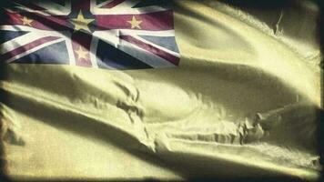 Retro aged Niue flag waving on the wind. Old vintage Niuean banner swaying on the breeze. Seamless loop. video