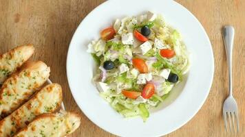 Top view of greek salad in a bowl on table video