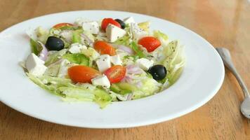 Healthy greek salad in a plate on table video