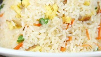 cooked fried rice in a bowl on table, close up video