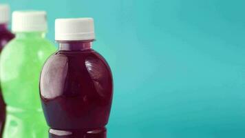 Plastic bottles of soft drink on table video