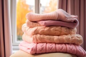 Laundry, housekeeping and homemaking, stack of clean and folded knitted clothes in the country house, photo