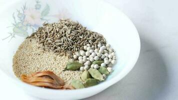 Mixed of different spice on a bowl on table video