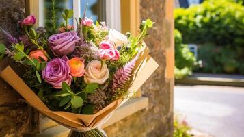Flower shop delivery and holiday gift postal service, beautiful bouquet of flowers on a house doorstep in the countryside, photo