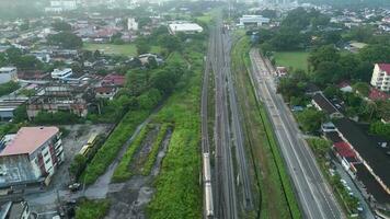 Aerial look down train move at suburban area Bukit Mertajam, Penang video
