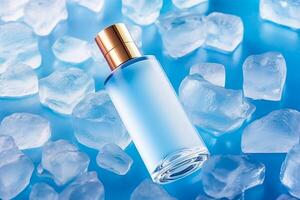 Skincare cosmetic bottle with golden cap on blue ice background, photo