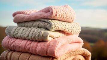 Laundry, housekeeping and homemaking, stack of clean and folded knitted clothes in the countryside, photo