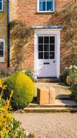 Postal service, home delivery and online shopping, parcel box on a house doorstep in the countryside, photo