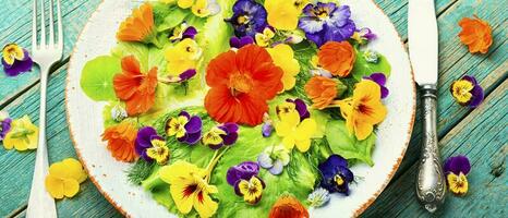 Spring salad with greens and edible flowers photo