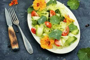 Vegetable salad with nasturtium flowers. photo