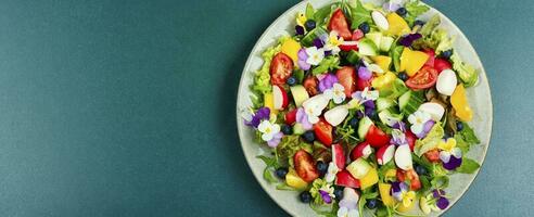 Summer salad with edible flowers,space for text. photo