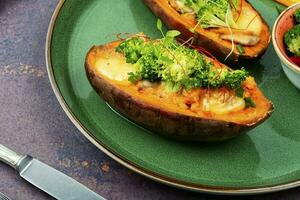 Baked sweet potato, yam with vegetable filling. photo