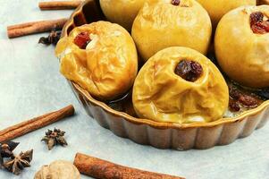Baked autumn apples with nuts and raisins photo