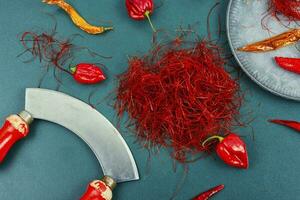 Cutting red chilly peppers. photo
