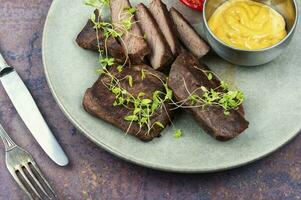 Grilled ostrich steak with sauce photo