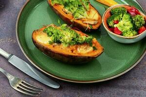 Baked sweet potato, yam with vegetable filling. photo