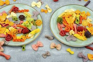 Colorful raw farfalle pasta photo