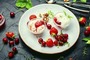 Tasty ice cream with berries and jam photo