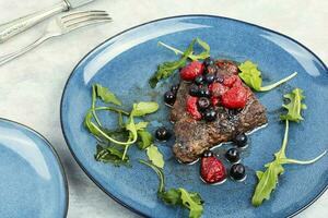 Beef steak roasted in berry sauce. photo