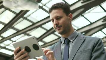 Young Attractive Man Using Mobile Tablet Screen on Business Travel video