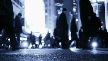 Crowds of people commuting in the city crossing street in rush hour traffic video