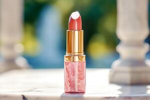 Luxurious pink lipstick in golden tube on marble, beauty cosmetic and luxury make-up product, photo