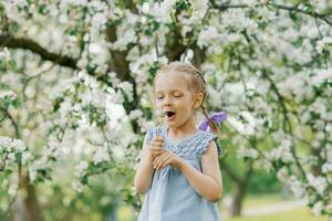 Beautiful child with dandelion flower. Happy kid having fun outdoors in spring park photo