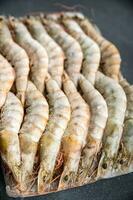 frozen shrimp raw gambas seafood prawn meal food snack on the table copy space food background rustic top view photo