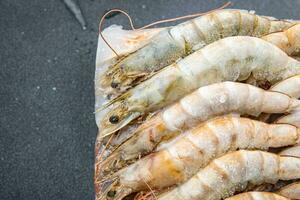 frozen shrimp raw gambas seafood prawn meal food snack on the table copy space food background rustic top view photo