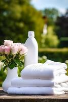 Laundry, housekeeping and homemaking, white clean folded clothes and detergent conditioner bottle in the garden, country cottage style, photo