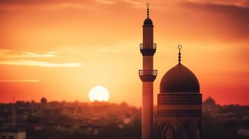 silhouette of muslim mosque minaret5 big sunset view in background. photo