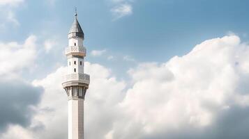 White mosque minaret. Mosque minaret with cloudy sky in background. photo