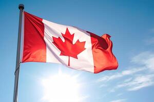 Canadian flag on clear blue sky. photo