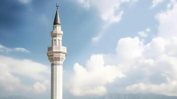 White mosque minaret. Mosque minaret with cloudy sky in background. photo