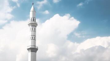 White mosque minaret. Mosque minaret with cloudy sky in background. photo