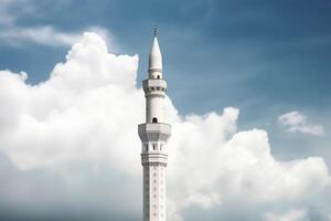 White mosque minaret. Mosque minaret with cloudy sky in background. photo