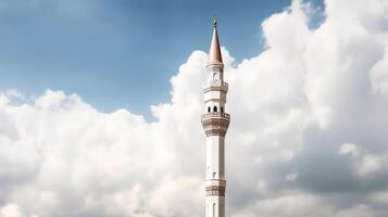 White mosque minaret. Mosque minaret with cloudy sky in background. photo