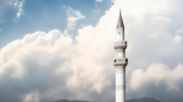 White mosque minaret. Mosque minaret with cloudy sky in background. photo