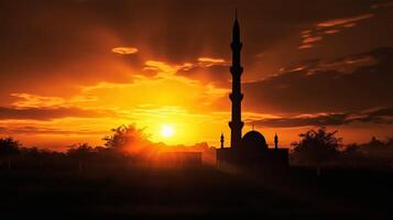 silhouette of muslim mosque minaret5 big sunset view in background. photo