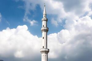 White mosque minaret. Mosque minaret with cloudy sky in background. photo