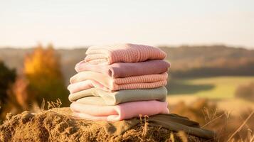 Laundry, housekeeping and homemaking, stack of clean and folded knitted clothes in the countryside, photo