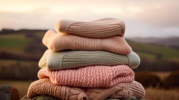 Laundry, housekeeping and homemaking, stack of clean and folded knitted clothes in the countryside, photo